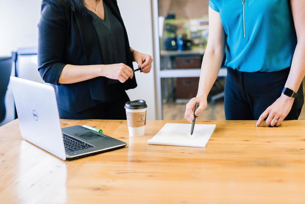 Close-up of two professionals in a discussion in a work environment