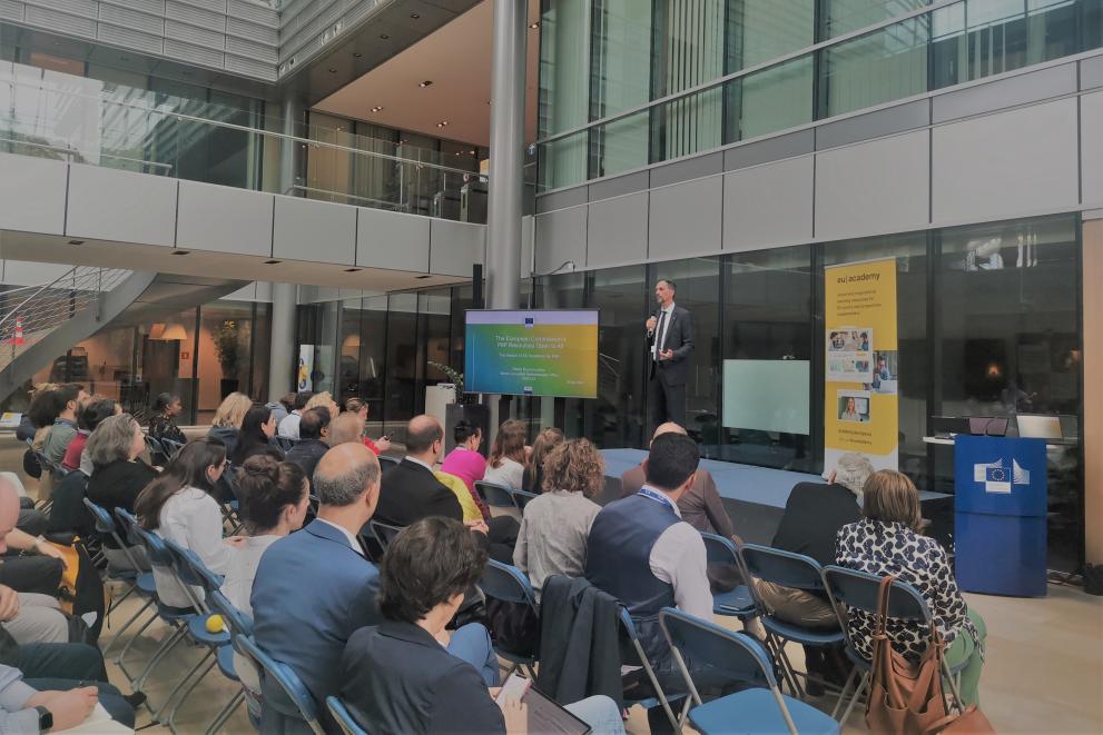 A professional presenting PM² at the EU Academy Conference in front of a big audience